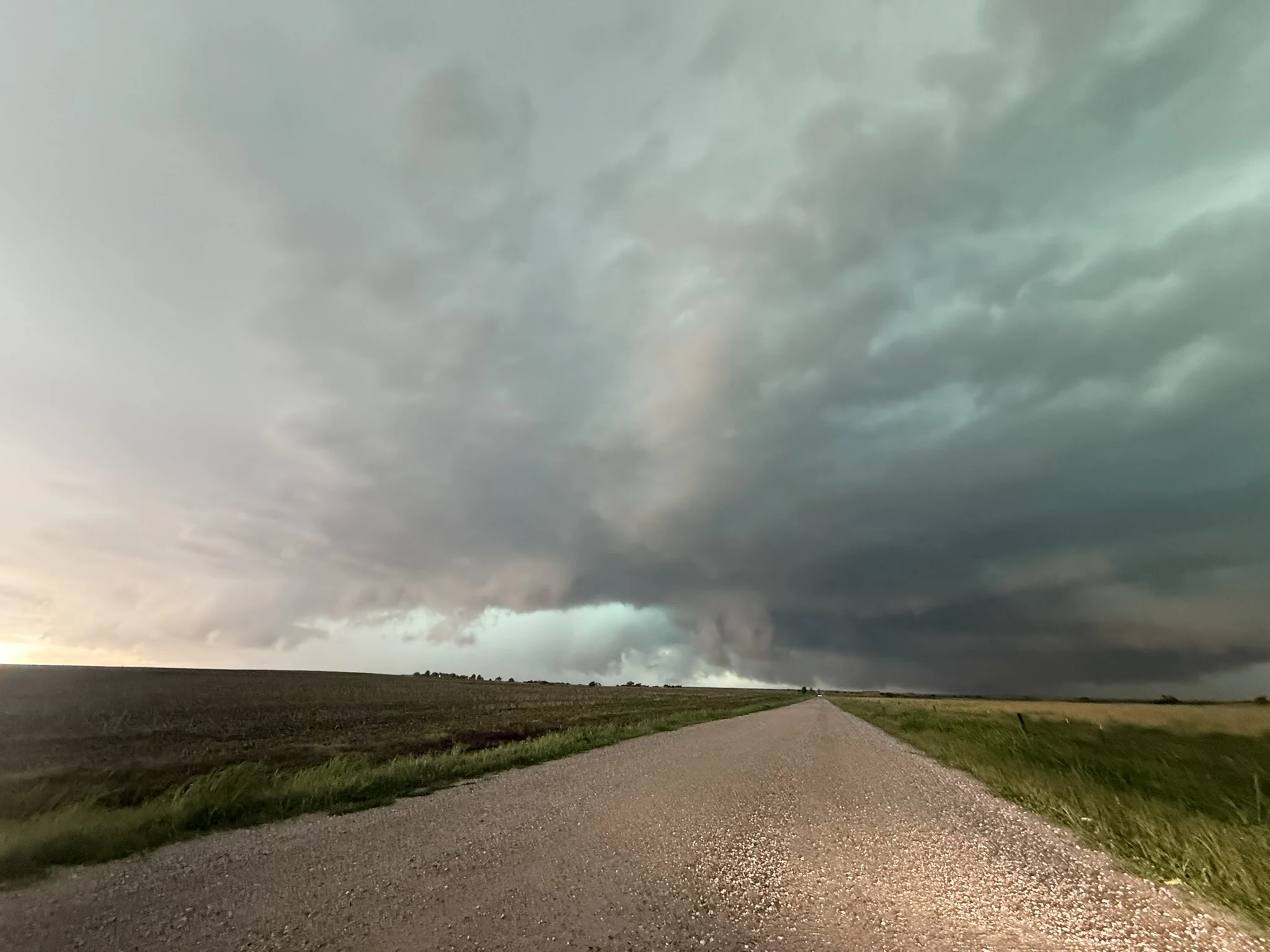 Layered storm clouds above a gravel road near Wellington, Kansas